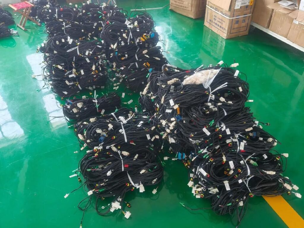 Wire harness assemblies bundled and labelled for export packaging at Nexharn factory