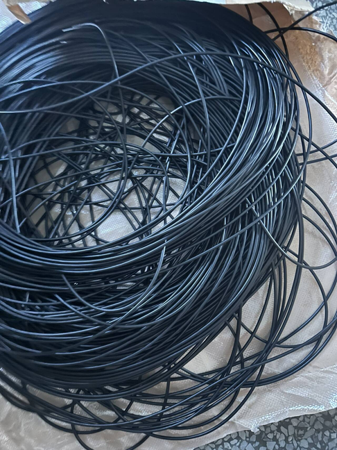 Black cable batch prepared for coiled cable production