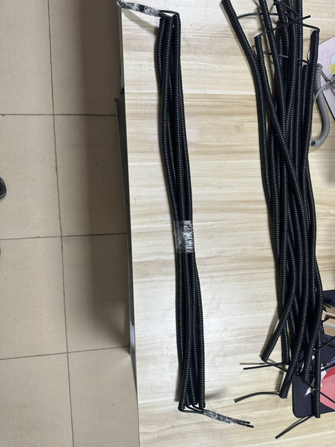 Finished custom coiled cable batch arranged for inspection